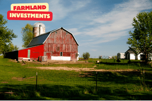 A red farm in the united States with green land and fields surrounding it.